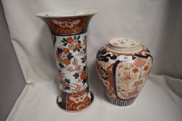 Two antique Japanese Imari wares including large trumpet form vase and lidded jar decorated with