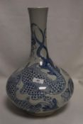 An oriental possibly Vietnamese bottle form squat vase decorated with typical blue and white