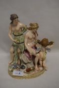 A Meissen marked figure group of a cherub with two semi nude maidens