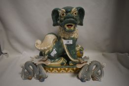 A modern ceramic Vietnamese dog of fo with two similar dragon figures