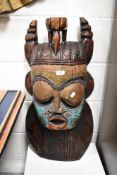 A large sized modern Maori tribal carved wood mask having copper and glass bead decoration approx