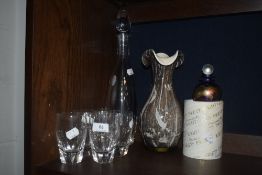 A modern clear cut glass decanter and tumbler set with a Phoenician glass blower of
