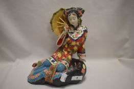 A Wanzpits Chinese Shi Wan porcelain figurine of a seated geisha