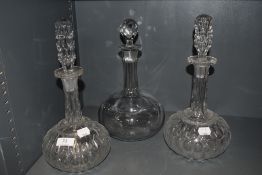 Three antique decanters including a matching pair with stoppers