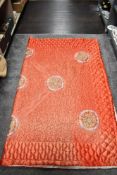 A vintage red satin embroidered oriental bed throw.