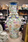 A large Chinese export hard paste floor vase, decorated in a Cantonese palette with moulded lizard
