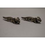 A pair of 20th century pewter figures or knife rests of foxes