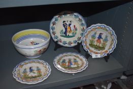 Four French HR Quimper plates and a porridge bowl all having typical delft style designs