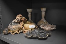 A selection of oriental soapstone carved objects including two candlesticks, two carved bowls and