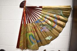 A large size Chinese fan hand painted with dragons on gilt background