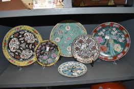 A selection of oriental and Chinese porcelain plates including hand decorated and famille Noire