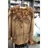 A vintage brown Antartex lamb skin jacket, having curly lining.