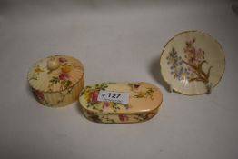 Three pieces of Royal Worcester including lidded trinket cases and a miniature pin dish