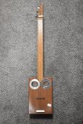 A modern cigar box guitar or banjo with carry bag