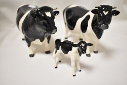 A family of modern Beswick Fresian cows and calf marked CH Claybury Leegwater and CH Coddington Hilt