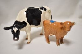 A Border Fine Arts ceramic figure study of a Fresian Cow with a Beswick calf AF