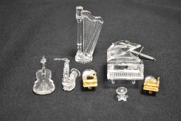 A set of modern Swarovski silver crystal glass figurines of orchestral musical instruments from