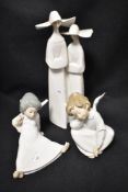Three modern Lladro figurines including Angel seated, a pair of Nuns and Angel sat AF