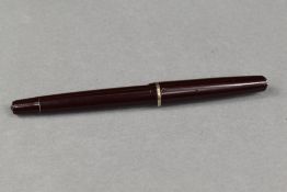 An Osmiroid 75 vacuum fill fountain pen in brown with single narrow band to the cap having