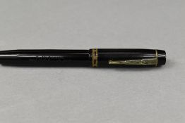A Unique leverfill fountain pen in black with decorative band to cap having Unique nib. Approx 12.