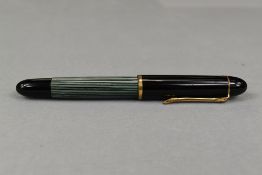 A Pelikan 140 piston fill fountain pen in green striated pattern and black cap having Pelikan 14ct