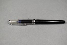 A Peliken Technos cartridge draftsmans pen in black with clear cap. Approx 13.9cm