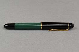 A Pelikan 120 piston fill fountain pen in green with black cap having Pelikan EF nib. Approx 12.4cm