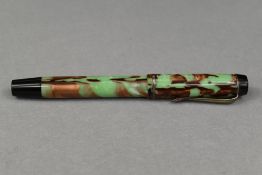 A Mentmore button fill fountain pen in green and gold marble with single band to the cap having