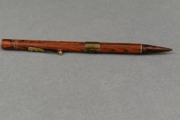 A Waterman propelling pencil in woodgrain pattern, 9ct gold band to barrel.