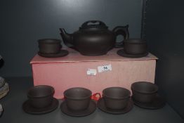 A modern Chinese Zisha teapot and bowls set having impressed marks to bases