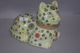 A Chinese porcelain figure of a cat with a millefiori style design bearing red seal mark to base