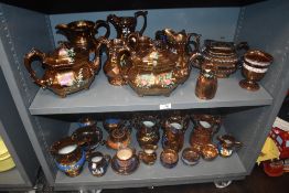 A large collection of early 20th century copper lustre wares including teapots and jugs etc