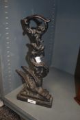 A Victorian cast iron door stop or porter in the design of a dragon wrapped around foliage