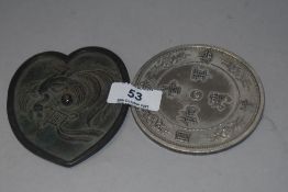 An 18th century Chinese bronze mirror having Phoenix decoration in a heart shape design with a