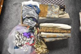 Two boxes full of good good quality fabrics, including upholstery fabric and some vintage dress