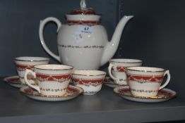 An early 20th century Ridgways part tea service in a red and gilt design