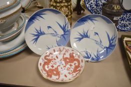 Three Chinese porcelain plates including two bird design and one red double dragon pattern