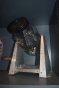 A 20th century kitchen counter top aluminium and glass jar butter churn
