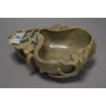 A 19th century Chinese pale jade carved bowl in the form of fungus with foliage handle