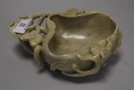 A 19th century Chinese pale jade carved bowl in the form of fungus with foliage handle
