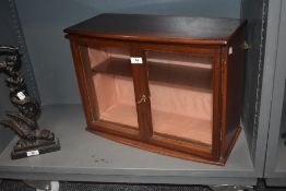 An early 20th century counter top shop display case with glass doors and mahogany frame with key