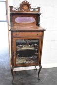 A 19th century mahogany and inlaid music or display cabinet having mirror back, width approx 57cm.