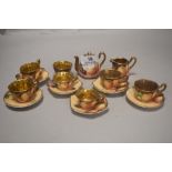 A miniature ceramic dolls house tea service with hand decorated and signed fruit pattern