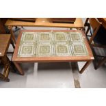 A vintage teak and textured tile top coffee table