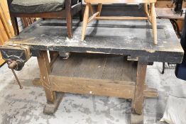 A large wooden work bench and vice