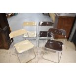 A set of four vintage folding chrome and plastic chairs