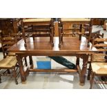 A traditional chunky oak drawer leaf dining table
