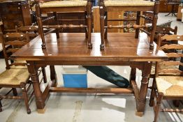 A traditional chunky oak drawer leaf dining table
