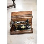 An antique Singer sewing machine, had crank operated with wooden case