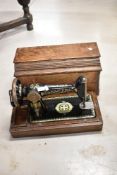An antique Singer sewing machine, had crank operated with wooden case